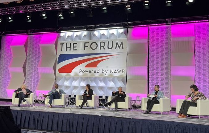 Preparing for an Inclusive Workforce panel discussion at The Forum Powered by NAWB. On the panel stage, sitting left to the right, Jane Oates, President, WorkingNation; Gary A. Officer, President &amp; CEO, Center for Workforce Inclusion; Debra Volzer, SME, Governments and Workforce Strategic Partnerships; Mindy Feldbaum; Luis A. Quinones, Unidosus, Senior Director of Adult Education and Workforce Development; Katie Brown, EnGen, Founder and Chief Education Officer