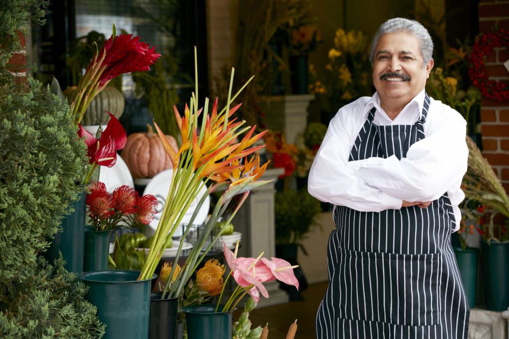 Portrait Of Male Florist Outside Shop Smiling To Camera.